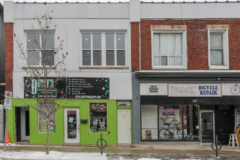 Red brick apartments above two local businesses.