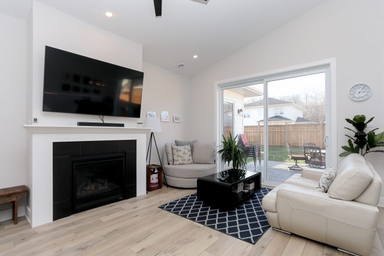 Open and bright modern living room with light leather sofa.