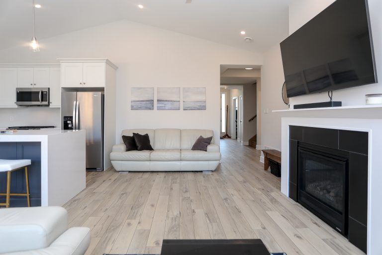 Open and bright modern living room with light leather sofa.