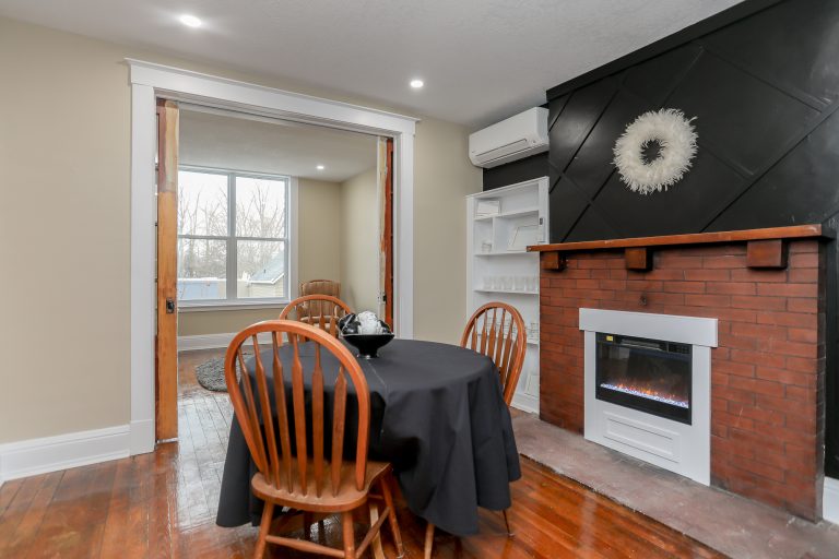 Small dining room with red brick fireplace.