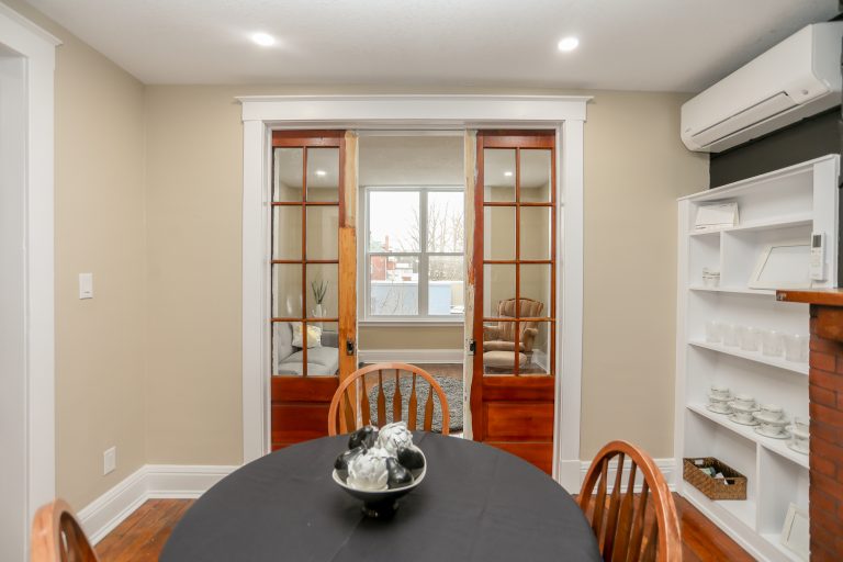 Dining room with white china cabinet beside the table.