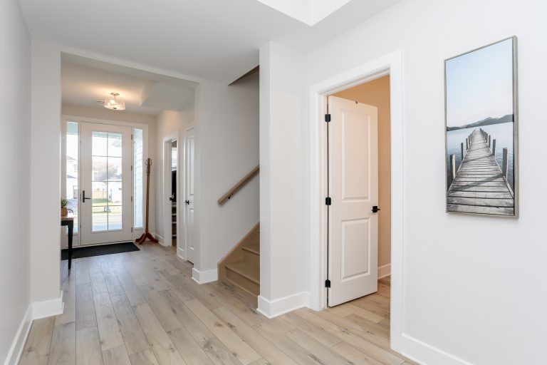 Open concept front hallway with beautiful light engineered hardwood.