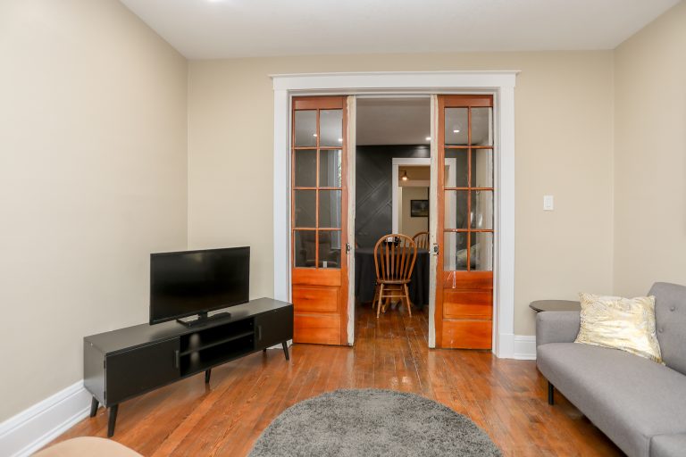 Cozy living room with natural wood floors and doors.
