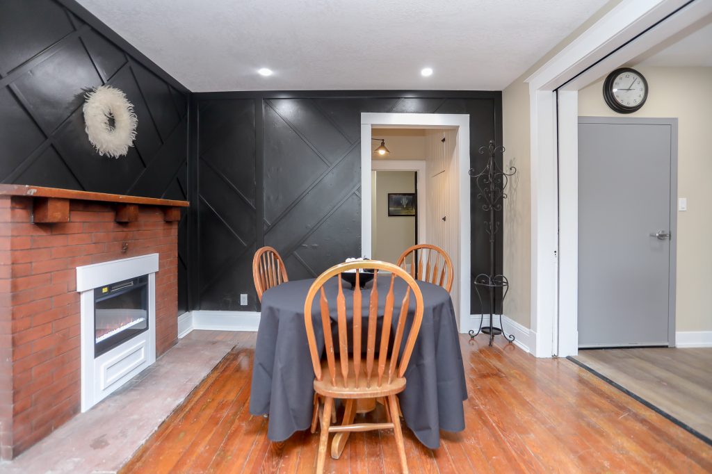 Small dining room with black decorative wall.