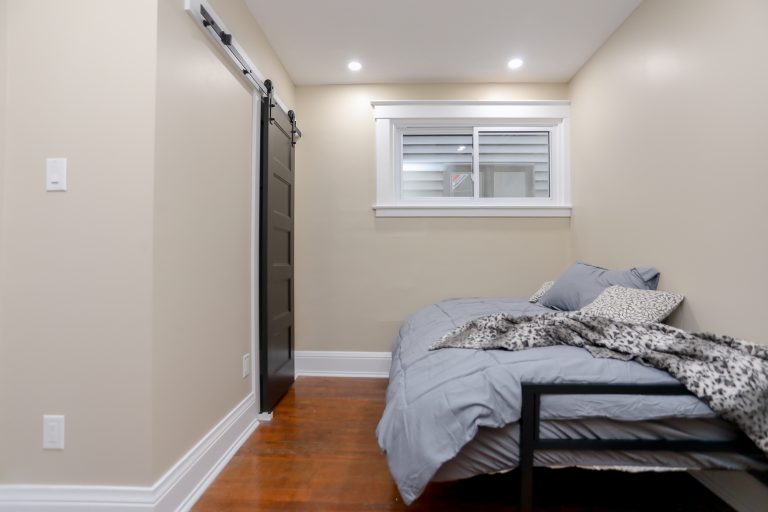 Bedroom with sofa bed and black barn door.
