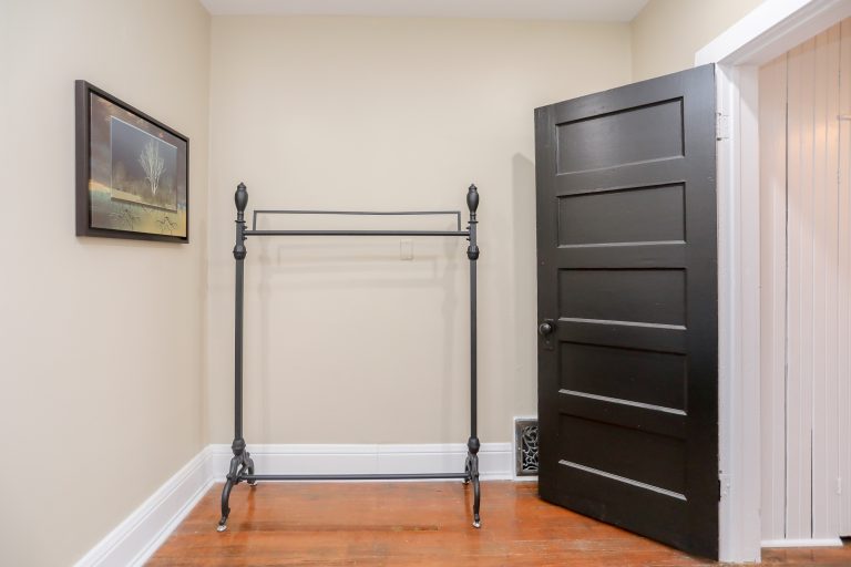 Beige room with black coat hanger.