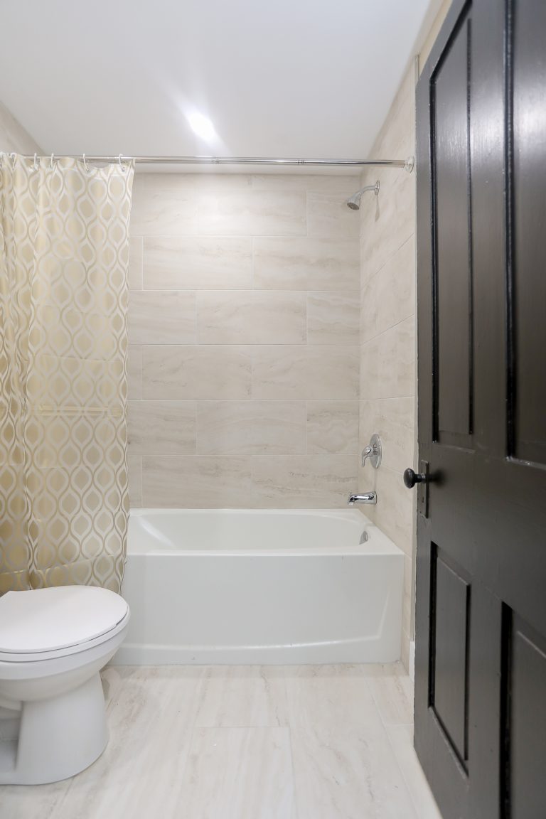 Light bathroom with tiled walls.