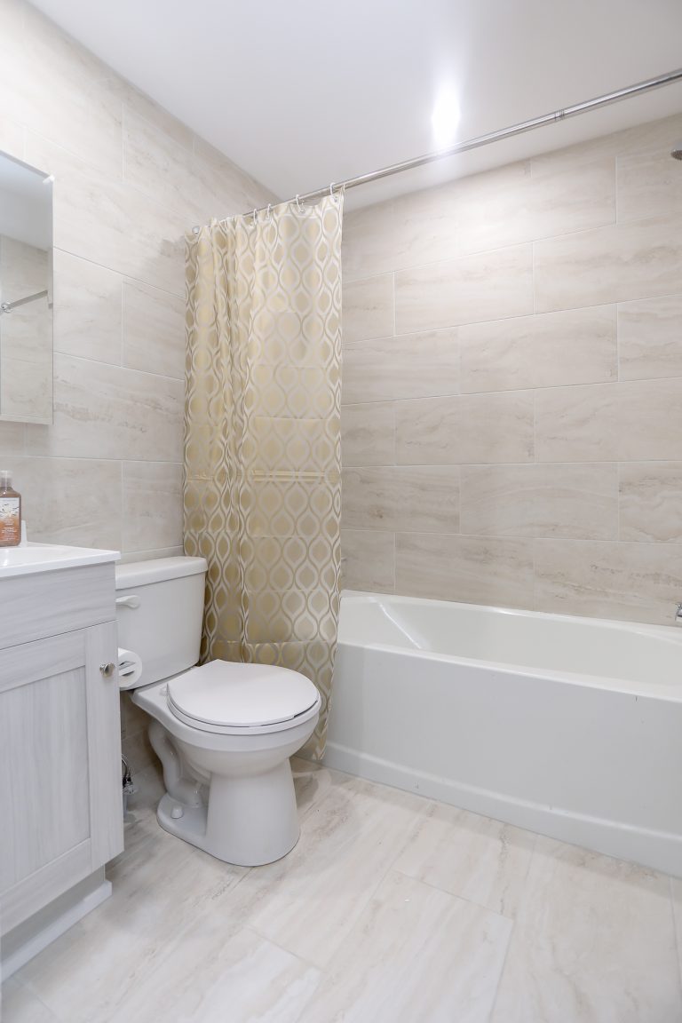 Light bathroom with tiled walls.