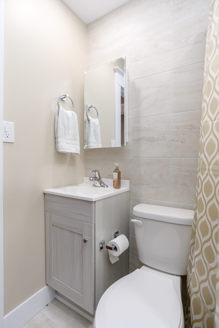 Light beige bathroom with small corner vanity