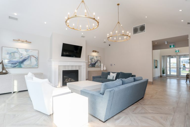 Bright modern living room with gold chandeliers.