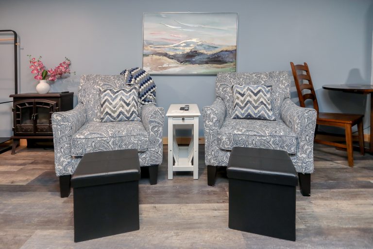 Cozy blue living room with patterned blue armchairs.