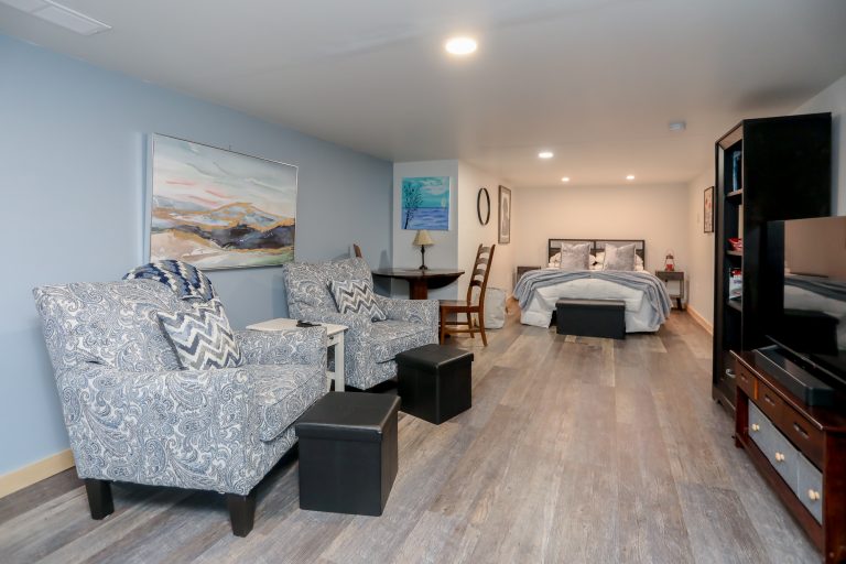 Cozy blue apartment with living area and bedroom.