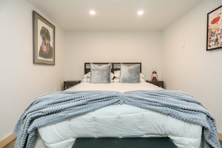 Bedroom with white bedspread and fuzzy blue blankets