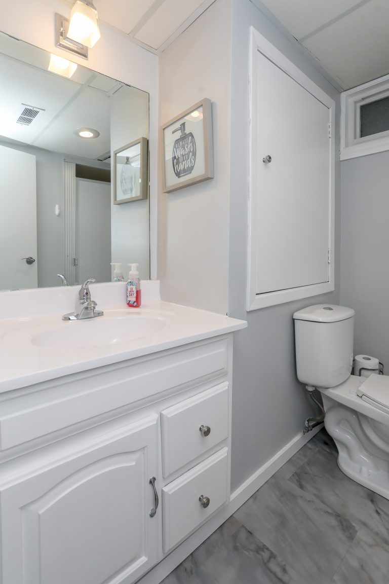 Small bathroom with white vanity.