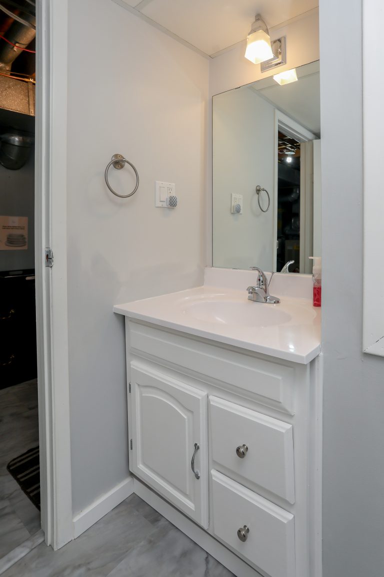 Small bathroom with white vanity.