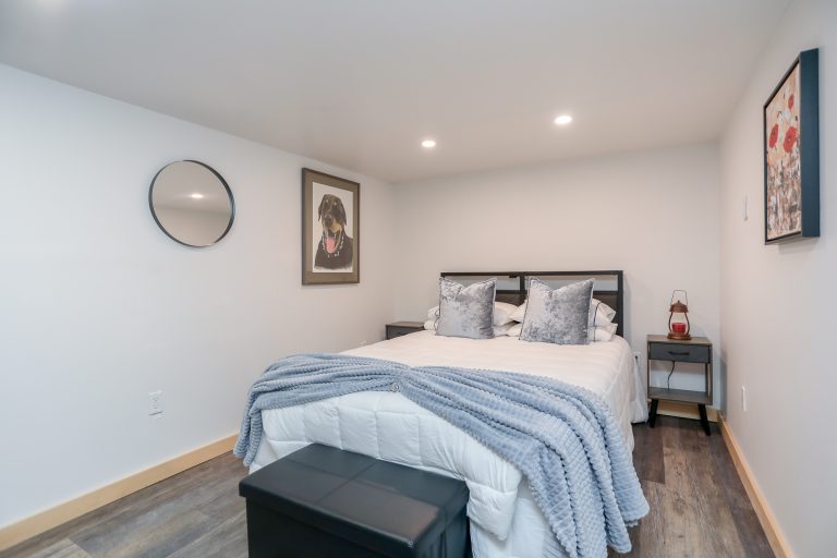 Bedroom with white bedspread and fuzzy blue blankets